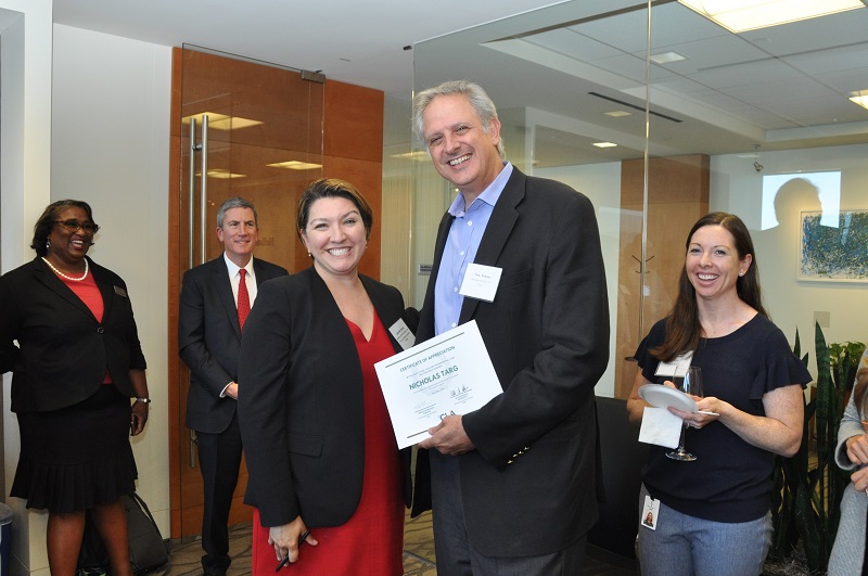 image of Jen Novak gives a certificate of appreciation to Nicholas Targ of Holland & Knight for his outstanding support.