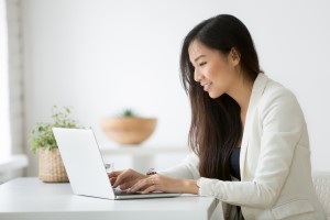 Woman working on laptop.