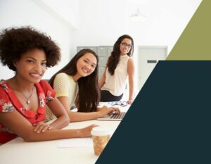 Three women sitting at a desk