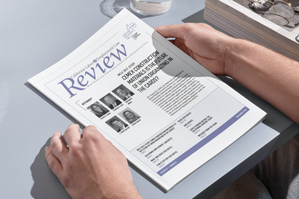 Print copy of the California Labor and Employment Law Review being held in human's hands on a table