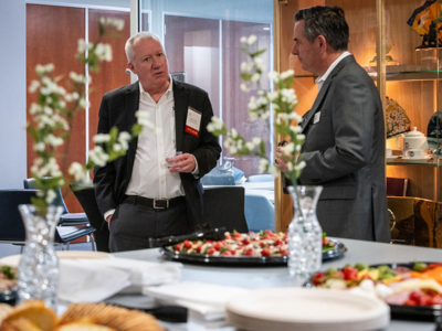 Speaker chatting with attendee over appetizers