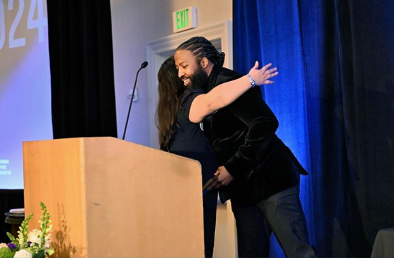 Recipient receiving award