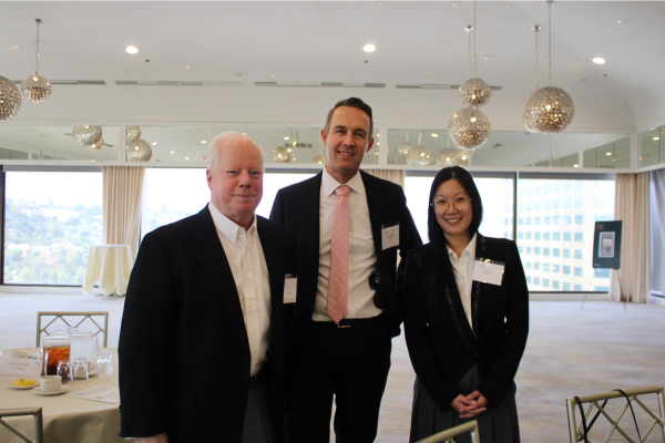 Three speakers posing for photo