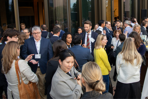 Wide shot of attendees socializing 