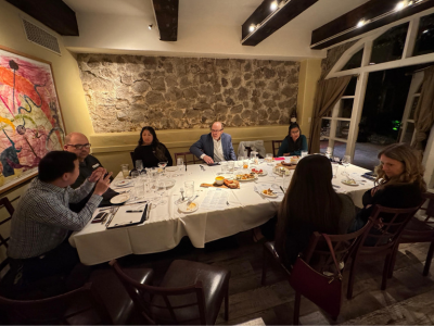 Attendees socializing at dinner table