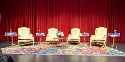 Four chairs on stage for upcoming fireside chat